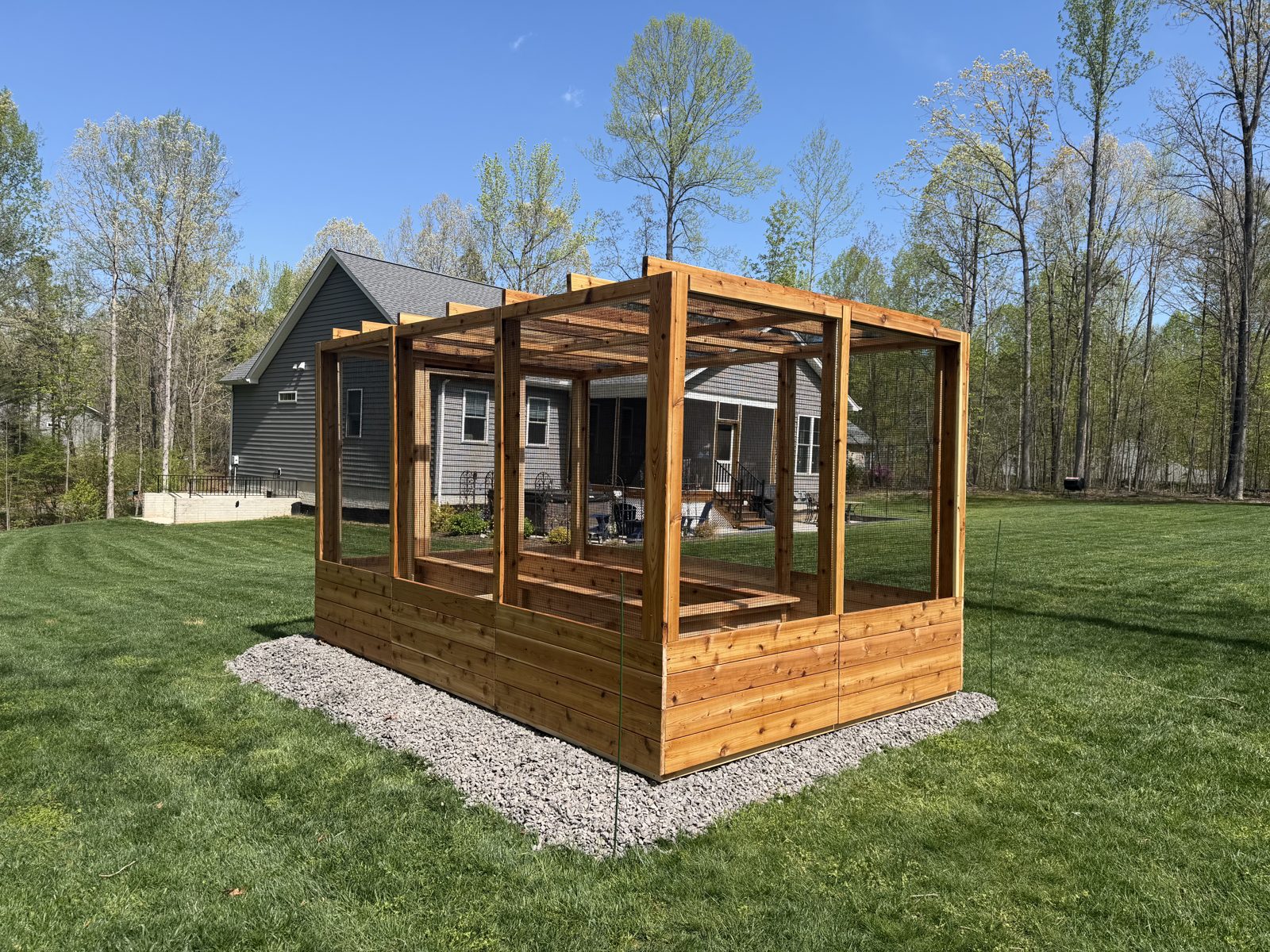 Handcrafted Western Red Cedar enclosed garden system in a landscaped backyard